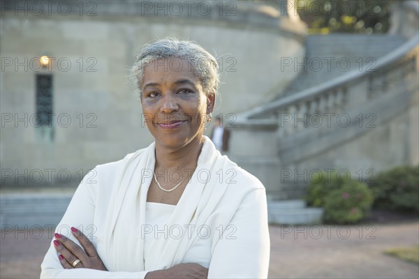 Portrait of Black woman posing near stone staircase
