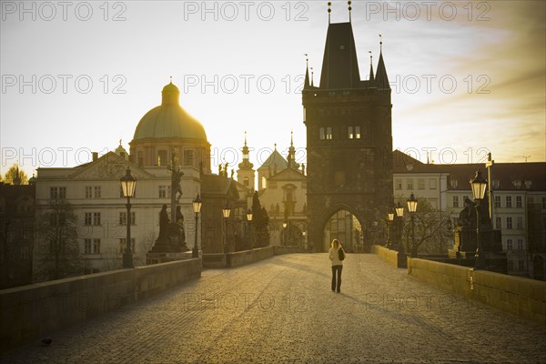 Distant woman standing on bridge in Prague