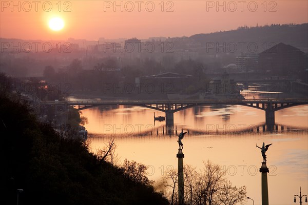 Sunset on bridge over river