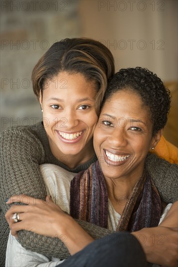 Portrait of smiling Mixed Race mother and daughter