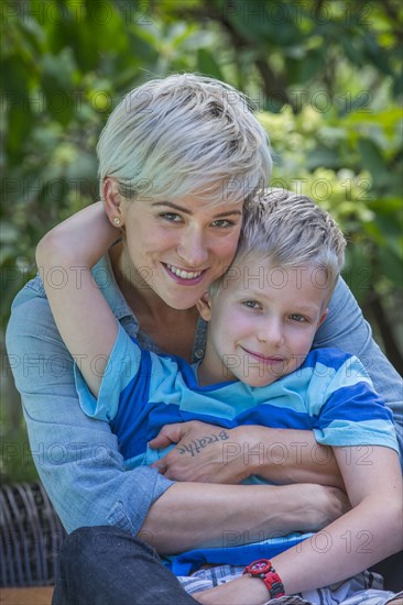 Caucasian woman hugging son outdoors