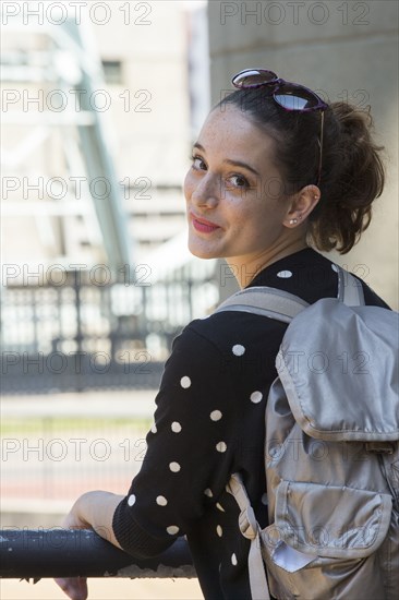 Portrait of smiling Caucasian teenage girl carrying backpack