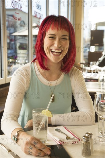 Caucasian woman laughing in restaurant