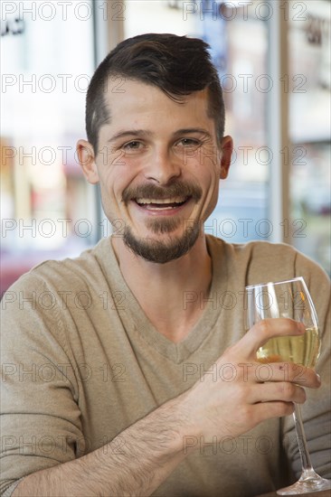 Portrait of Caucasian man drinking white wine