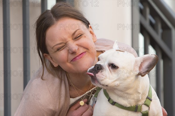 Portrait of Caucasian woman making a face with dog