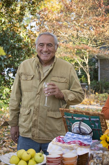 Hispanic man drinking wine outdoors