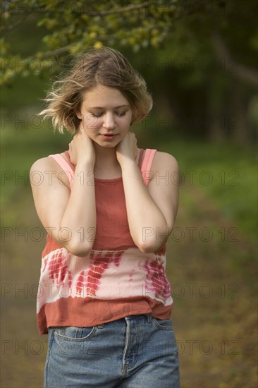 Wind blowing hair of pensive Caucasian teenage girl