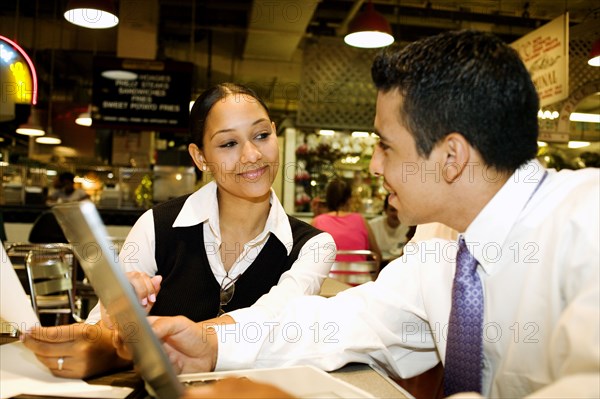 Business people working over lunch