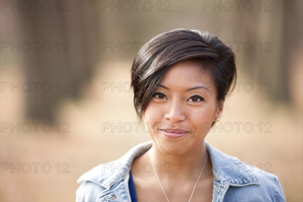 Smiling Asian woman outdoors