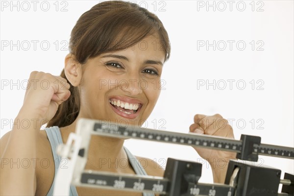 Portrait of woman weighing on scale