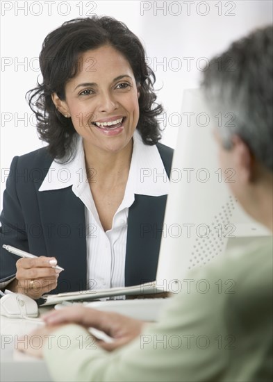 Businesswoman talking to male client