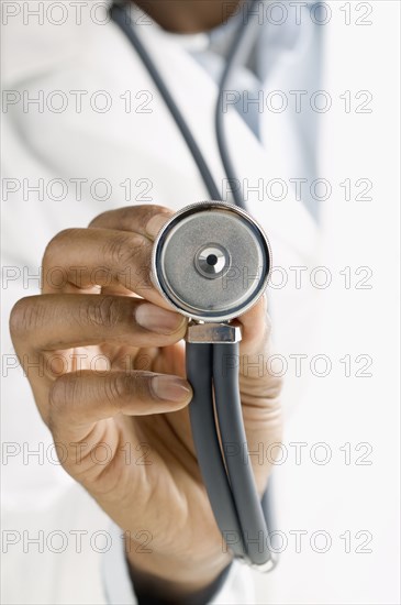 Close up of doctor's hand holding stethoscope