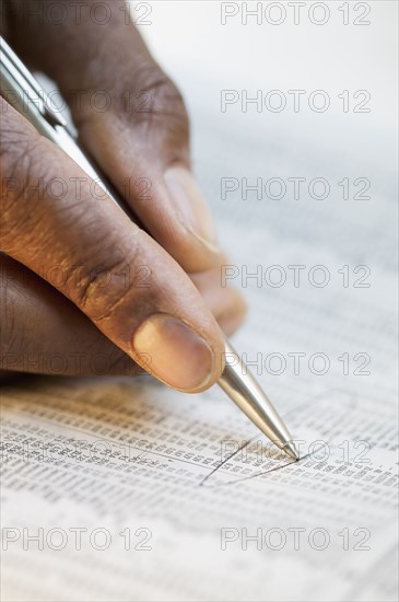 Close up of hand circling newspaper ad