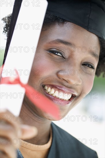 Portrait of woman graduate with diploma