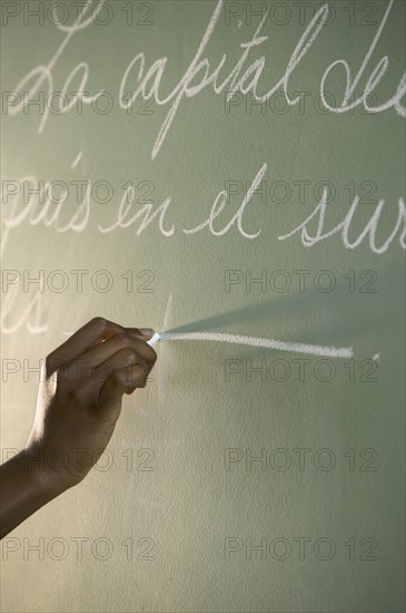 Hand writing on chalkboard