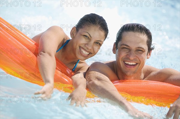 Portrait of couple in swimming pool