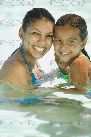 Portrait of mother and daughter swimming