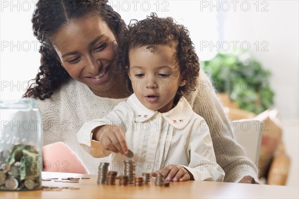 Mother and daughter counting coins