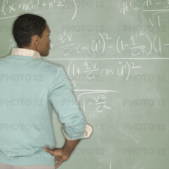 Rear view of man at chalkboard