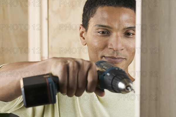 Man drilling hole with power drill