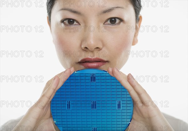 Portrait of woman holding blue disk