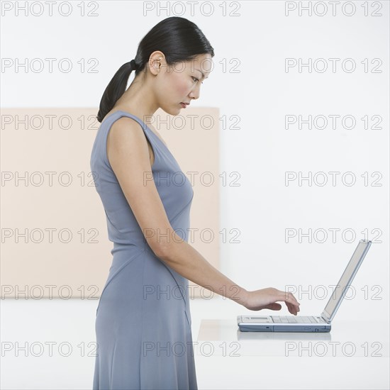 Side view of woman typing on laptop