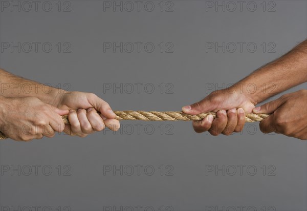 Close up of tug-o-war with four hands