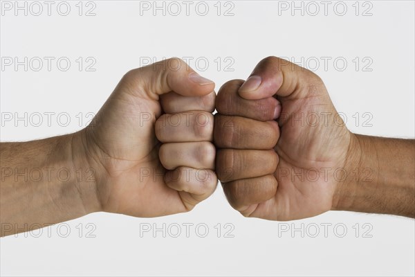 Close up of two hands touching knuckles together