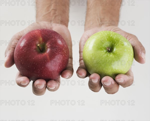 Close up of hands holding two apples