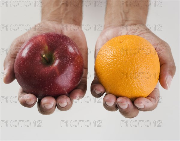 Close up of hands holding two apples