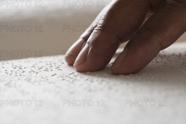 Close up of hand reading Braille