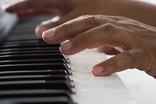 Close up of hands playing piano