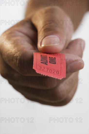 Close up of hand holding ticket