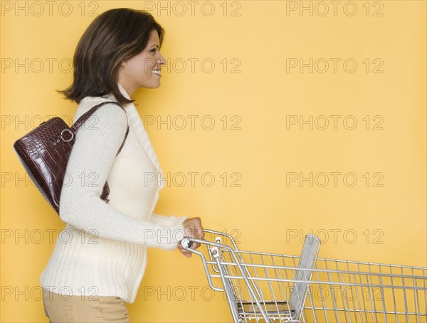 Profile of woman pushing shopping cart