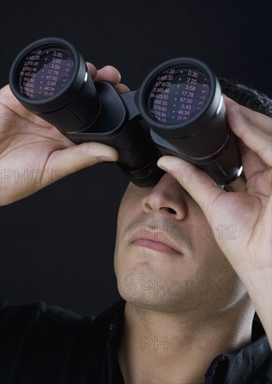 Man looking through binoculars