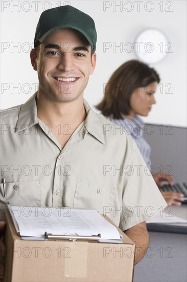 Portrait of delivery man with box