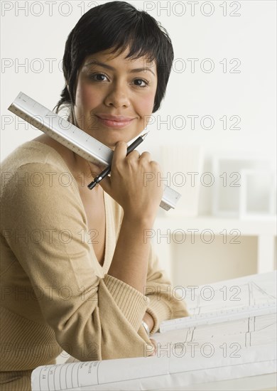 Portrait of woman with ruler and plans