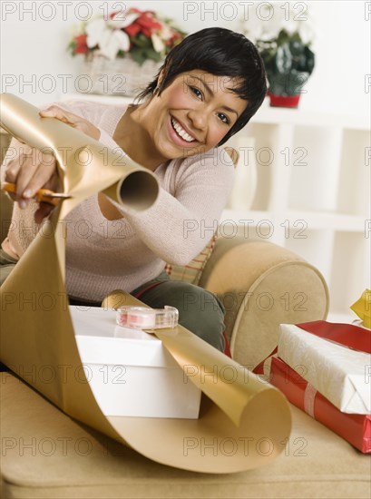 Portrait of woman wrapping gifts