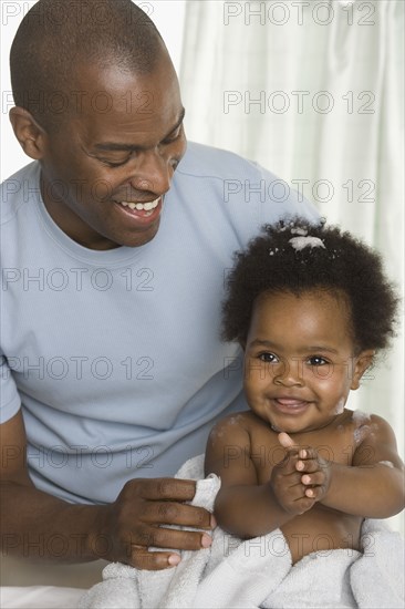 Father giving his baby daughter a bath