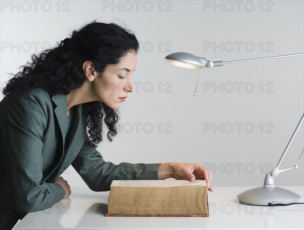 Woman reading thick book