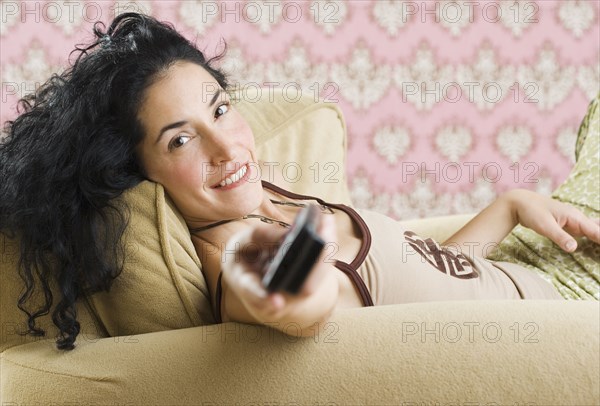 Woman pointing remote at the camera
