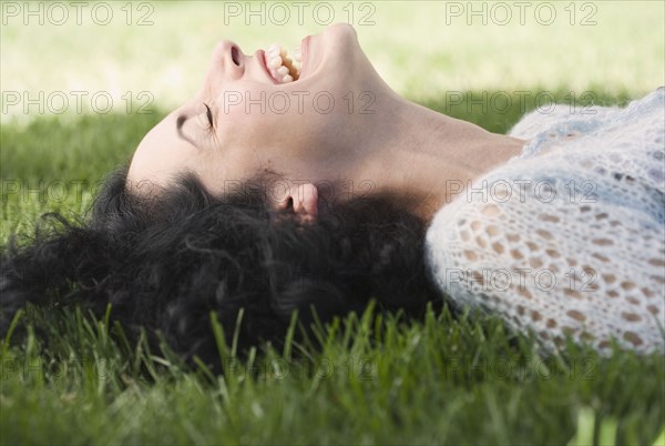 Young woman laying on grass