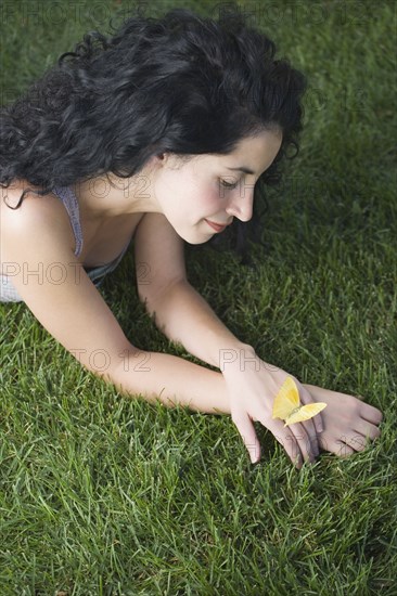 Butterfly resting on young woman's hand