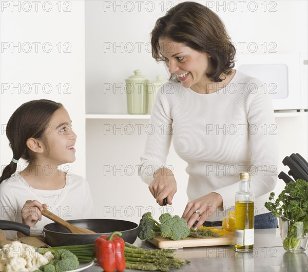 Mother and daughter cooking together