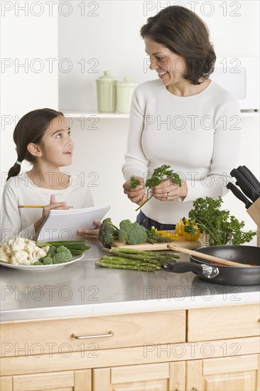 Mother and daughter cooking together