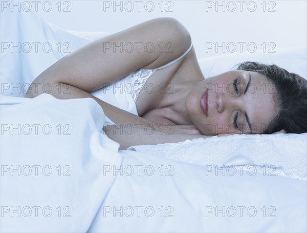 Young woman asleep in bed