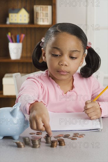 Young girl counting coins