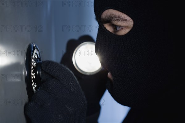 Thief unlocking a combination lock