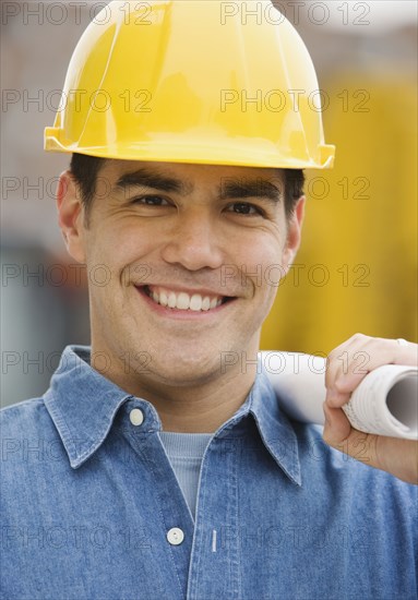 Manual worker holding blueprints