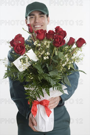 Mailman carrying a bunch of roses